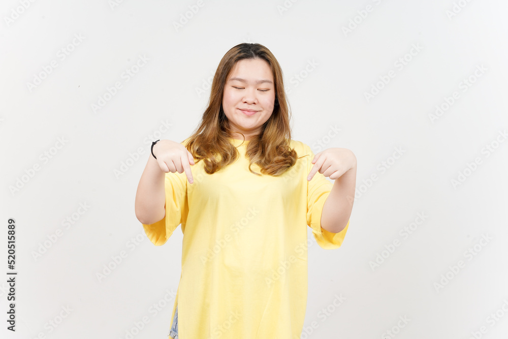 Pointing down and showing blank copy space of Beautiful Asian Woman wearing yellow T-Shirt Pointing down and showing blank copy space of Beautiful Asian Woman wearing yellow T-Shirt
