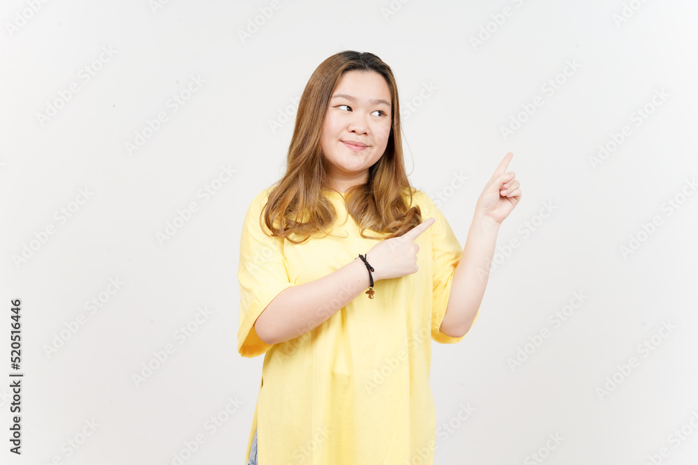 Showing Product and Pointing Side of Beautiful Asian Woman wearing yellow T-Shirt Isolated On White Showing Product and Pointing Side of Beautiful Asian Woman wearing yellow T-Shirt Isolated On White