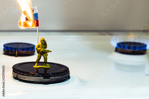 Russian soldier holds a burning flag. Gas issue and economics. Russia is losing