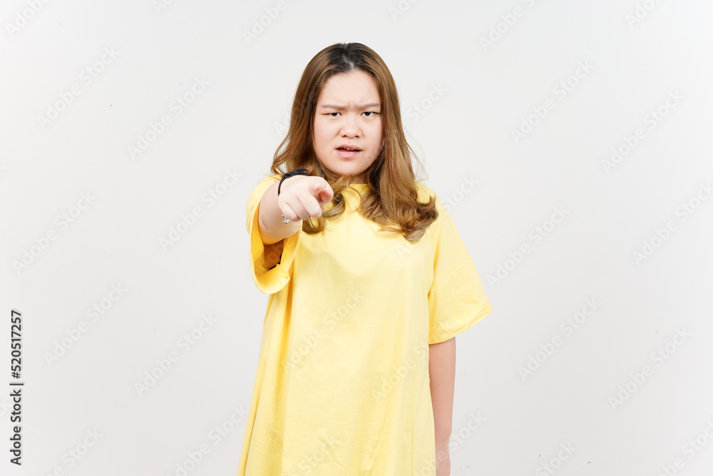 Angry expression and Pointing at camera of Beautiful Asian Woman wearing yellow T-Shirt