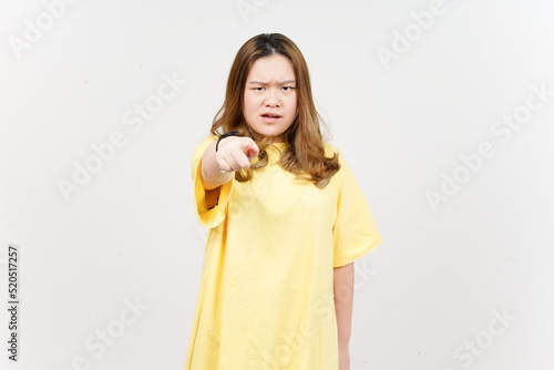 Angry expression and Pointing at camera of Beautiful Asian Woman wearing yellow T-Shirt