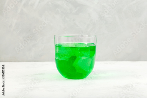 Khus Sharbat or Green Vetiver Drink. Glass of Chrysopogon zizanioides extract with ice cubes. Popular Indian refreshing drink photo