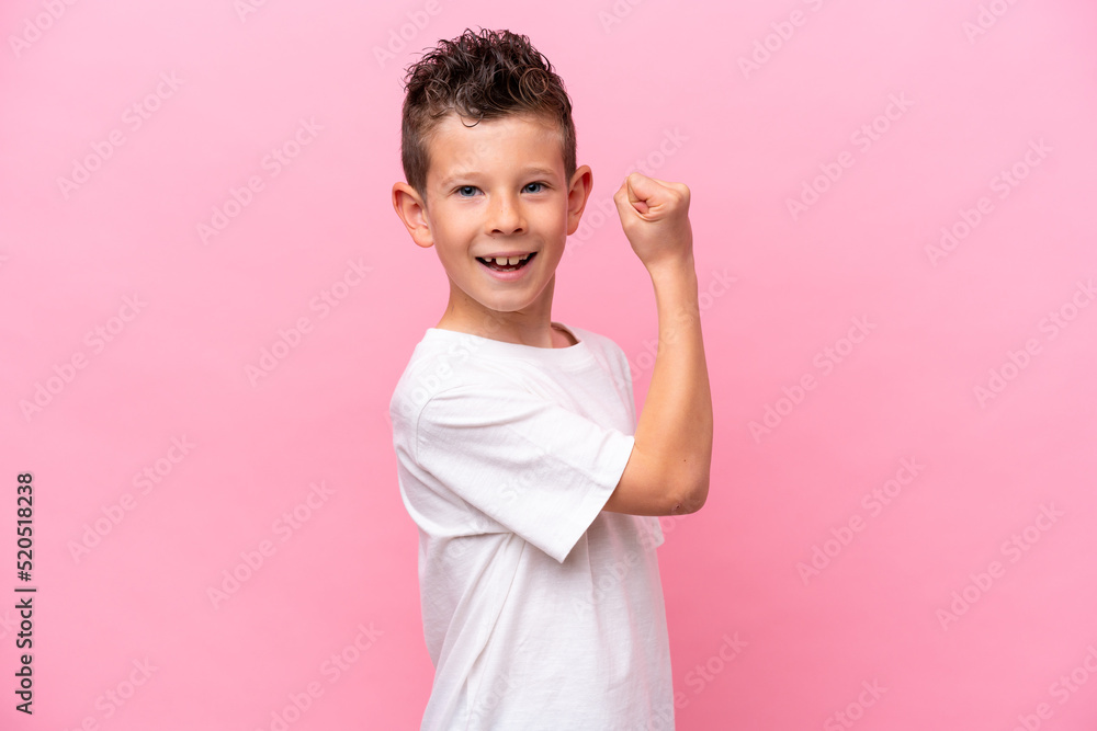Little caucasian boy isolated on pink background doing strong gesture Little caucasian boy isolated on pink background doing strong gesture