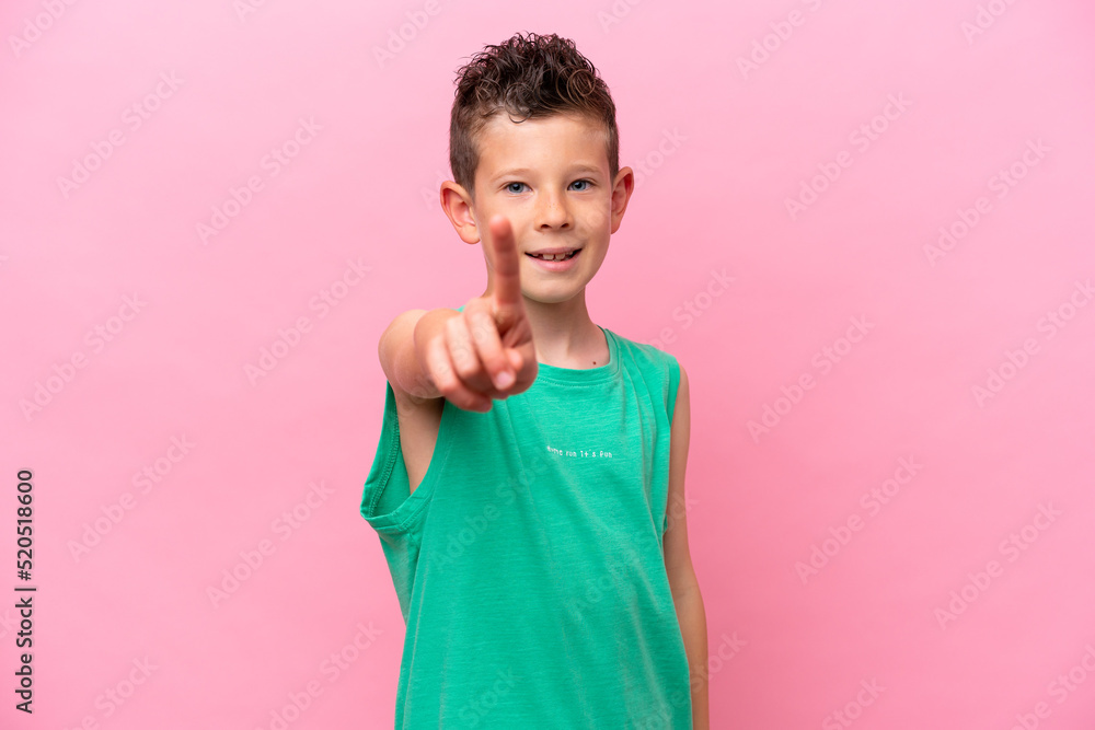 Little caucasian boy isolated on pink background showing and lifting a finger Little caucasian boy isolated on pink background showing and lifting a finger