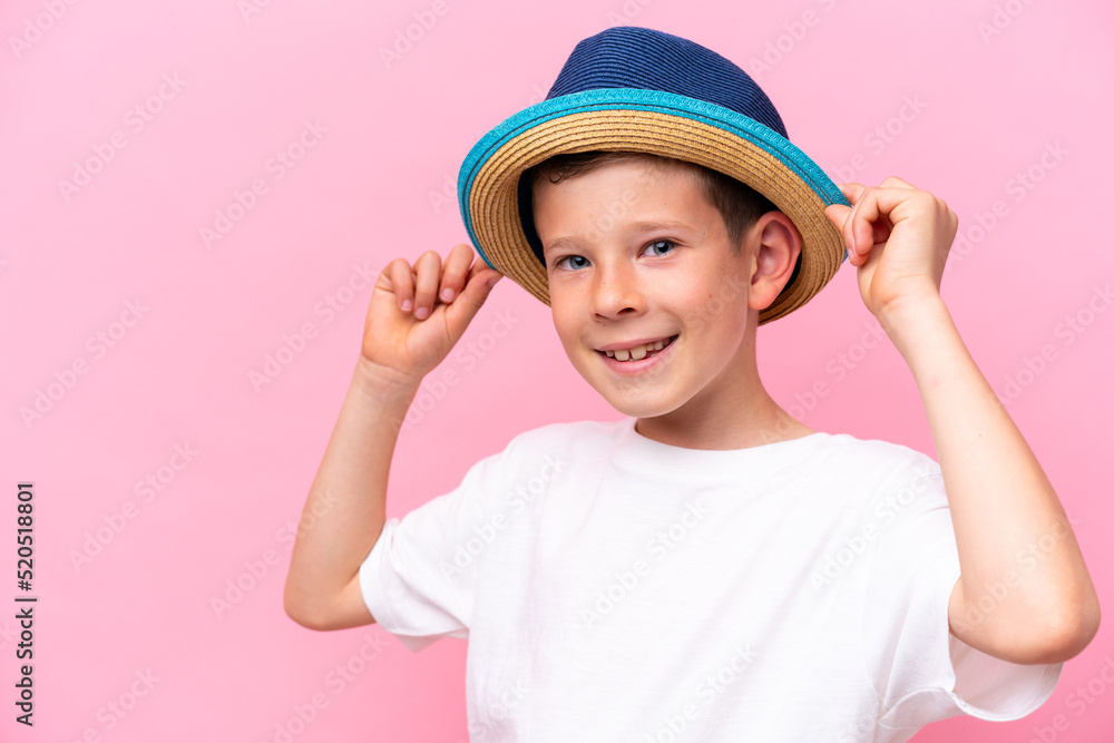 Little caucasian boy wearing a hat isolated on pink background Little caucasian boy wearing a hat isolated on pink background