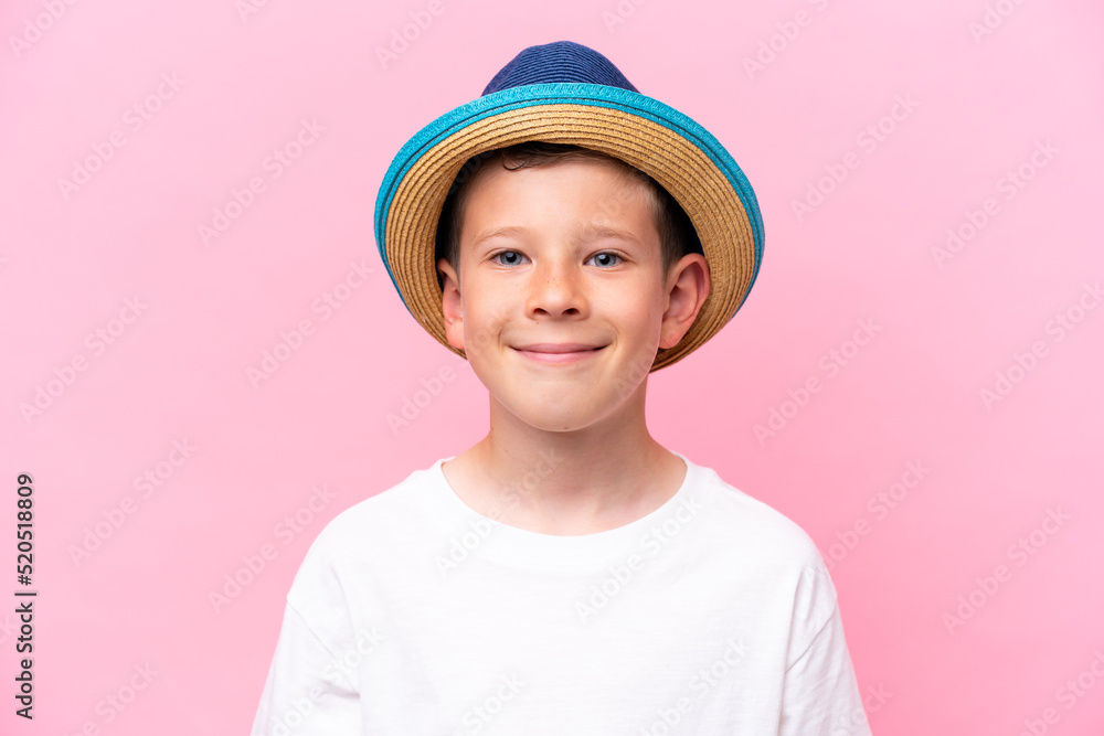 Little caucasian boy wearing a hat isolated on pink background Little caucasian boy wearing a hat isolated on pink background