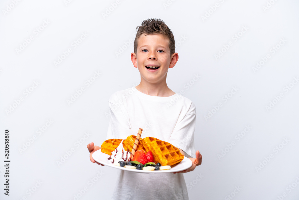 Little caucasian boy holding a waffles isolated on white background Little caucasian boy holding a waffles isolated on white background