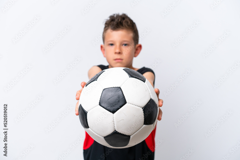 Boy playing football over isolated white wall Boy playing football over isolated white wall