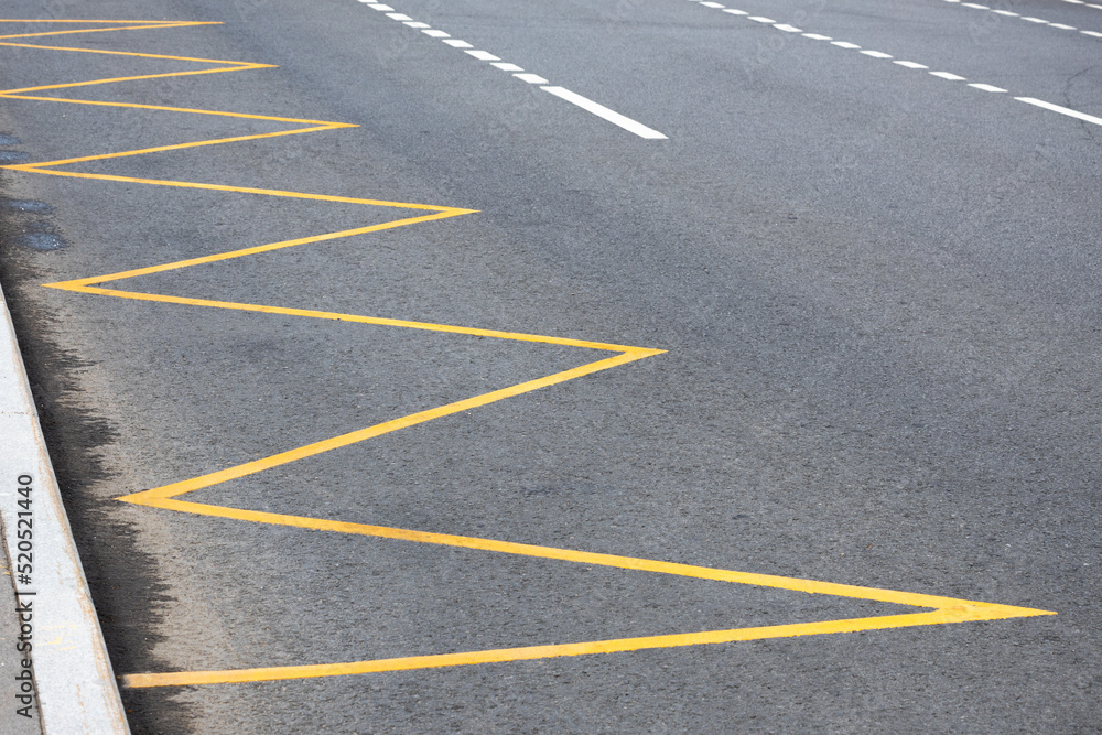 yellow road markings on the road at public transport stops