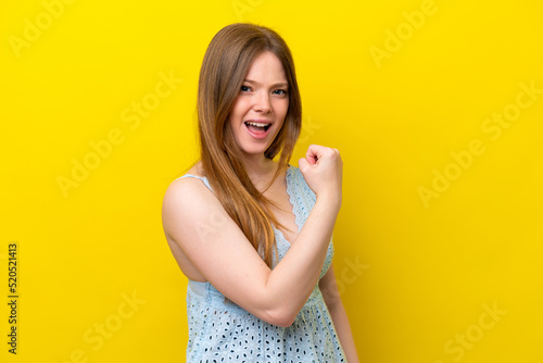 Young caucasian woman isolated on yellow background celebrating a victory © luismolinero