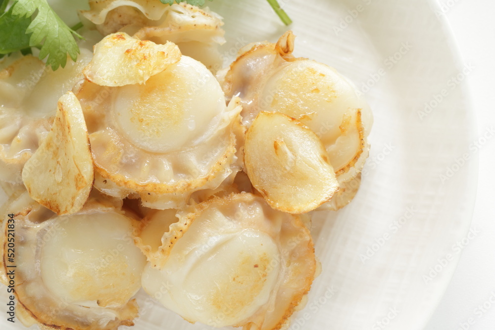 Chinese food, garlic stir fried with scallop served with coriander leaves Chinese food, garlic stir fried with scallop served with coriander leaves