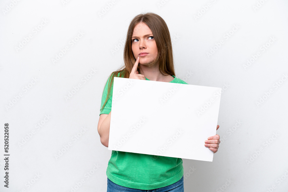 Young caucasian woman isolated on white background holding an empty placard and thinking Young caucasian woman isolated on white background holding an empty placard and thinking