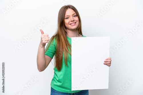 Young caucasian woman isolated on white background holding an empty placard with thumb up
