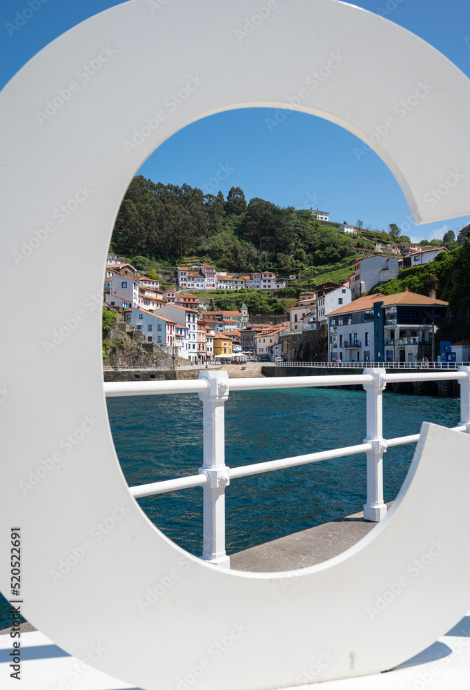 Fototapeta premium View through a sign the fishing village of cudillero