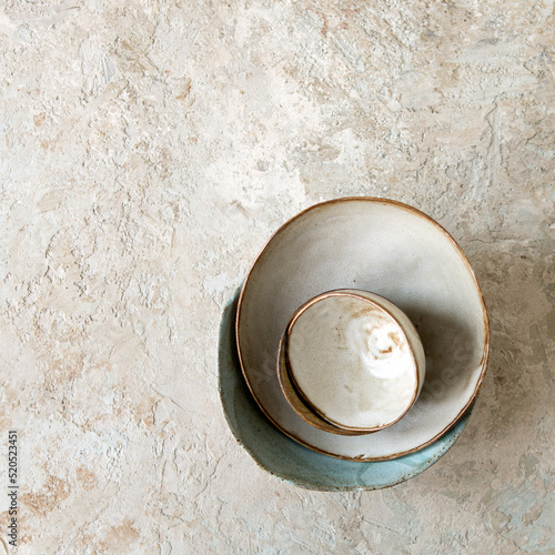 Fototapet a set of handmade ceramic bowls on a light table