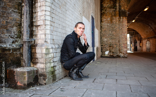 Urban attitude: bad habits. An alternative lifestyle character smoking a cigarette; from a series of images with the same model.