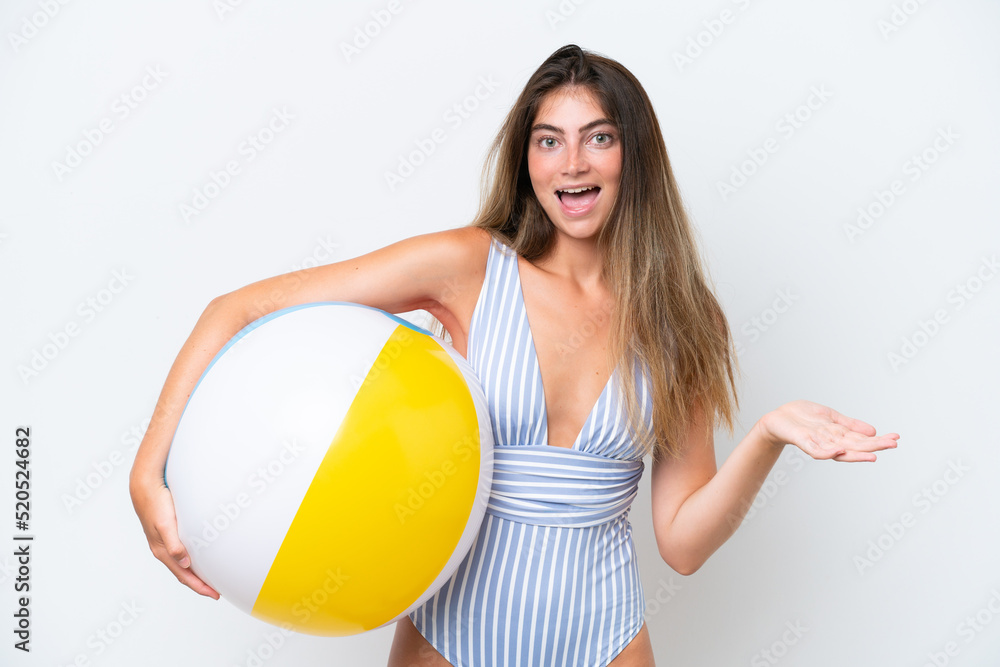 Young woman in swimsuit holding beach ball isolated on white background with shocked facial expression Young woman in swimsuit holding beach ball isolated on white background with shocked facial expression