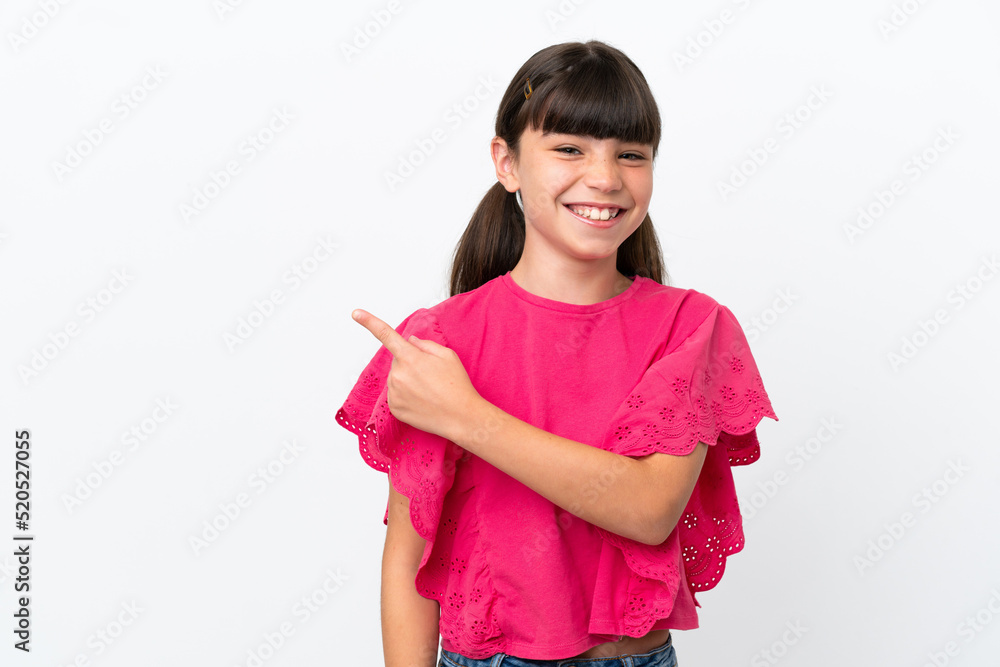 Little caucasian kid isolated on white background pointing to the side to present a product
