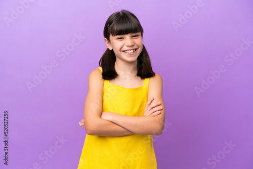 Little caucasian kid isolated on purple background keeping the arms crossed in frontal position