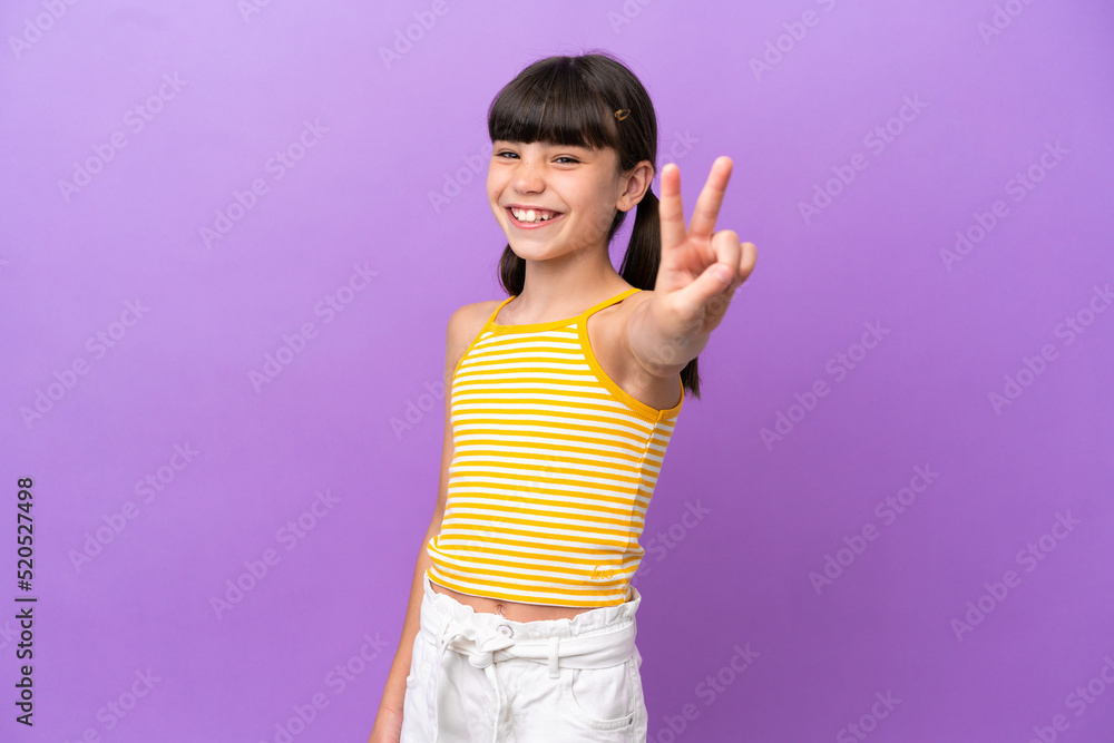 Little caucasian kid isolated on purple background smiling and showing victory sign Little caucasian kid isolated on purple background smiling and showing victory sign