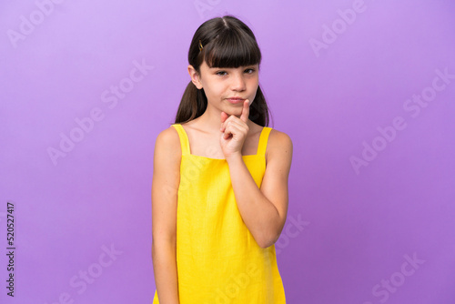 Little caucasian kid isolated on purple background and thinking