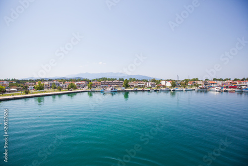 Panoramic view of Keramoti, small town, and port in Greece. Seascape. Beautiful blue water and sky. Summer day. Travel holiday vacation. 