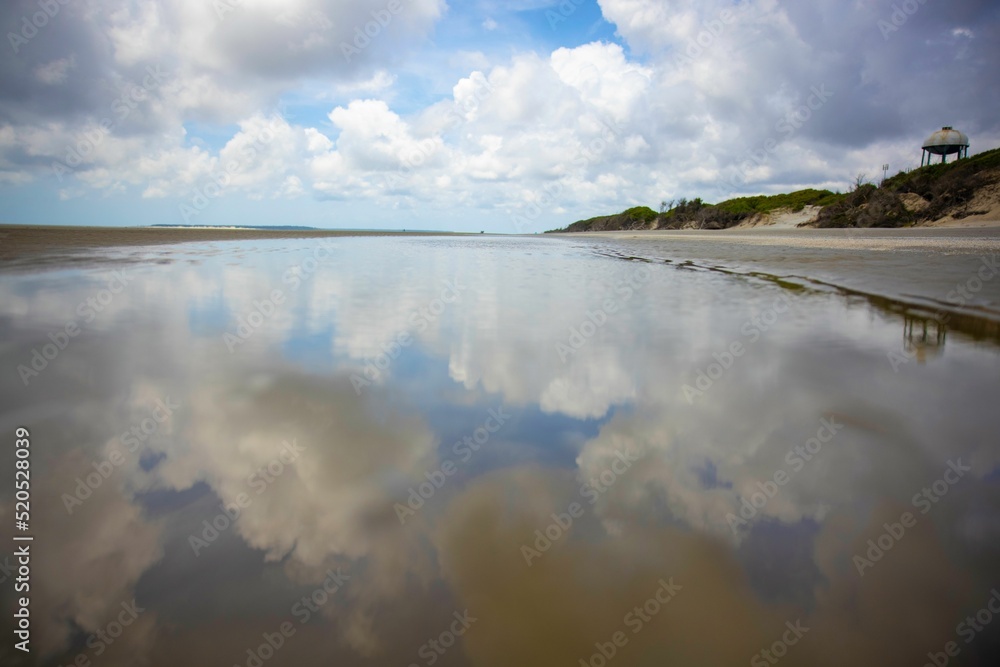 Tide pool with clouds reflection in Jekyll Island, GA Stock Photo