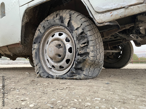 Flat tire of SUV after driving on a mountain road