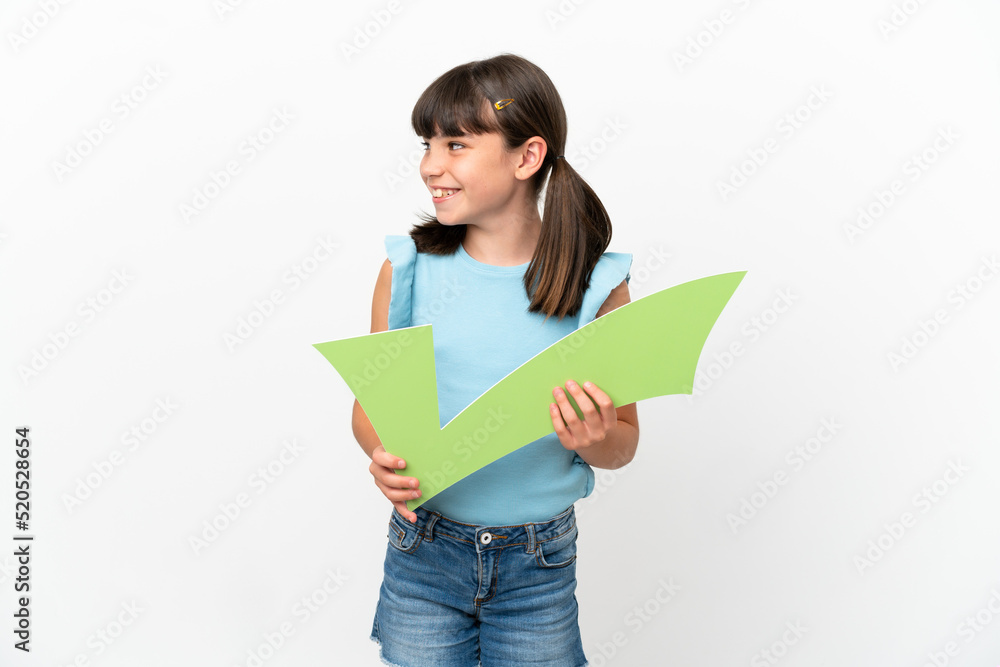 Little caucasian kid isolated on white background holding a check icon and looking side Little caucasian kid isolated on white background holding a check icon and looking side