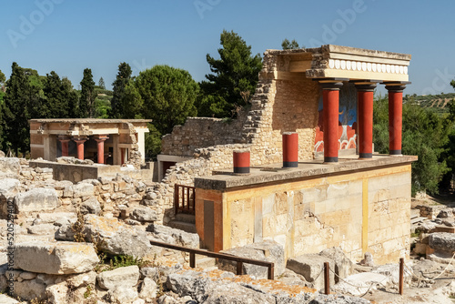 Knossos palace in Heraklion, Crete island, Greece. Details of ancient architecture - red Minoan columns and wall painting. Travel vacation concept. photo