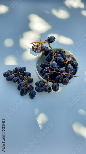 High angle, Purple grapes in bowl with stalk isolated on white background and shadow 01