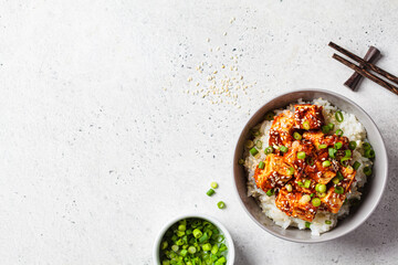 Korean dubu-jorim - braised spicy bean curd with rice in gray bowl, light background. Asian vegetarian food concept.