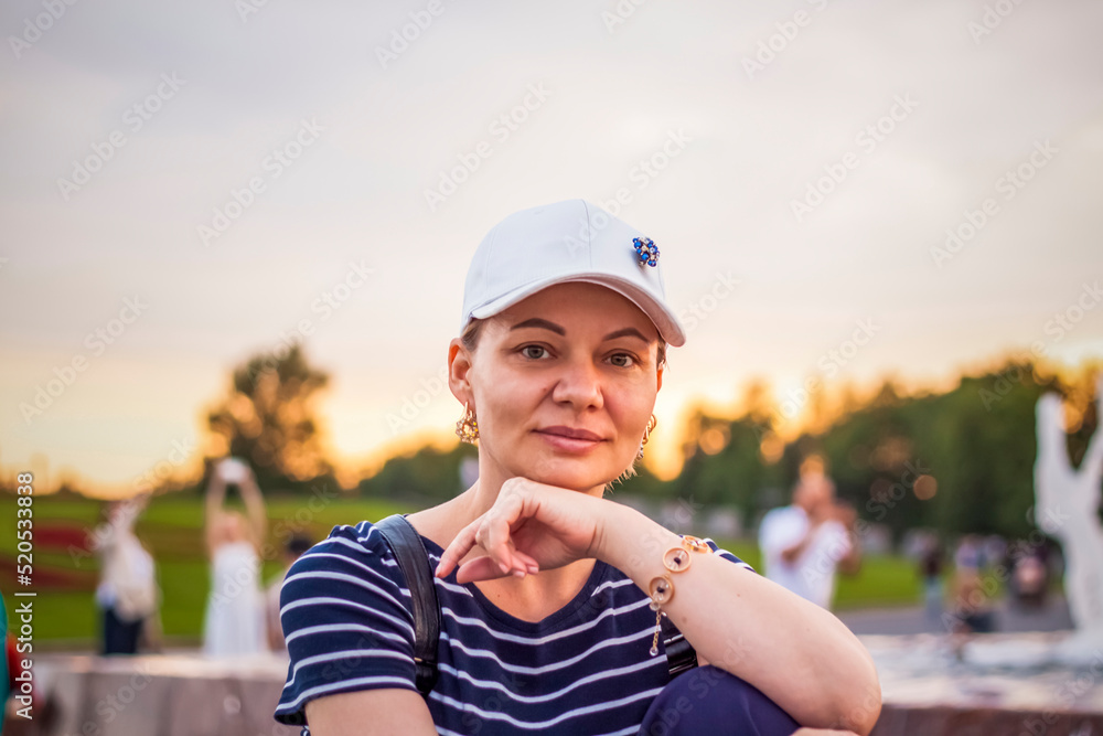 Portrait of a girl in a cap on the background of an open-air urban landscape. Travel. Lifestyle in the city. Center, streets Portrait of a girl in a cap on the background of an open-air urban landscape. Travel. Lifestyle in the city. Center, streets