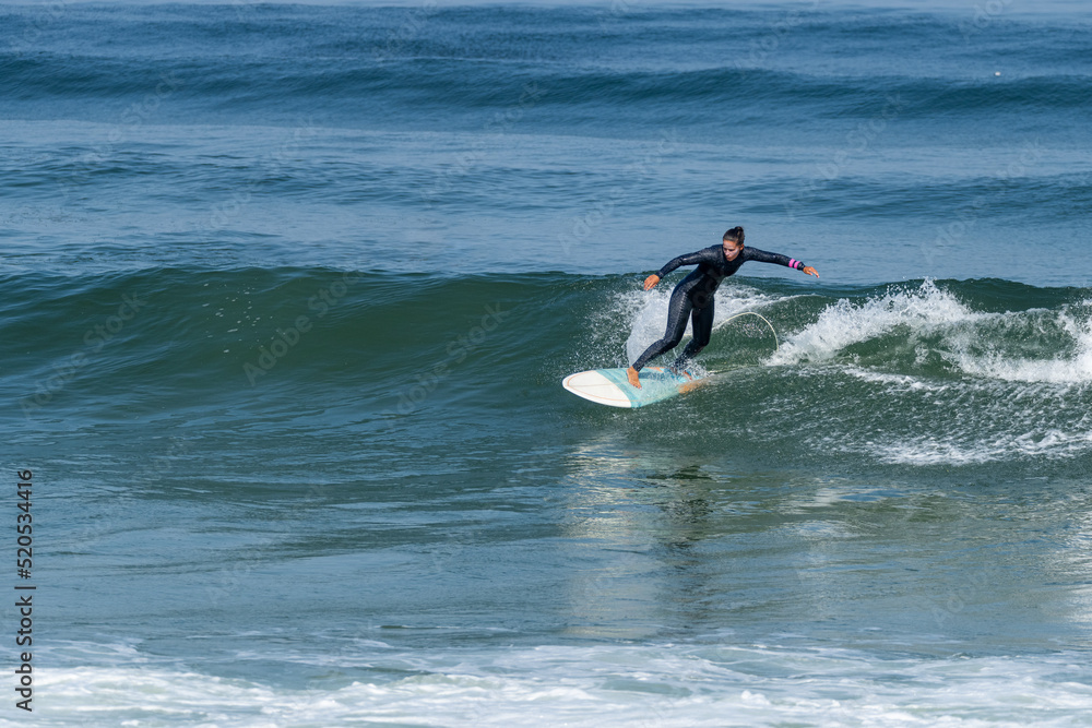 Surfer girl riding a wave