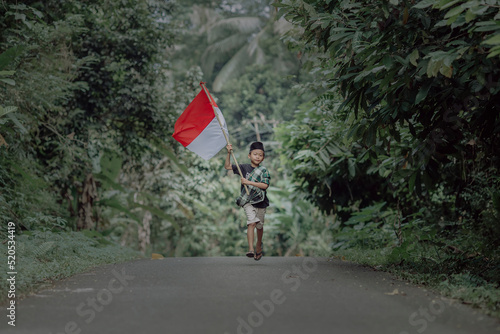 Wallpaper Mural child running holding indonesian flag Torontodigital.ca
