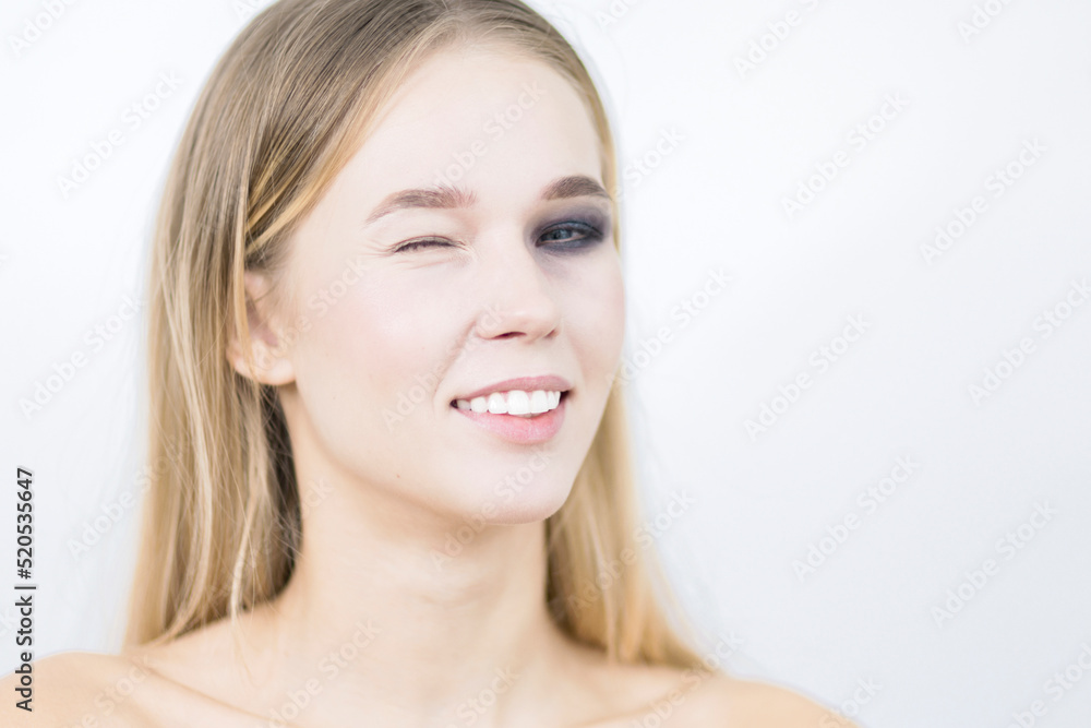 Smiling girl with one eye makeup. Close-up. Smiling girl with one eye makeup. Close-up.
