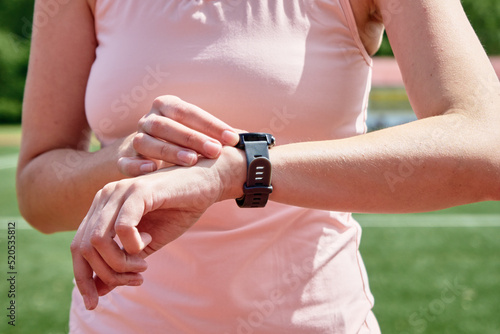 Woman use fitness watch before cardio exercises, Checking results on smart watch after training, Healthy lifestyle concept