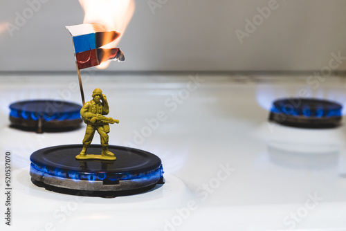 Russian soldier holds a burning flag. Gas issue and economics. Russian flag