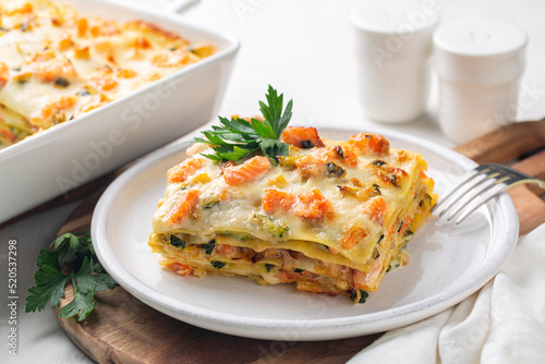 Fotografie Lasagna with salmon fish, zucchini, bechamel sauce, parmesan cheese and leek