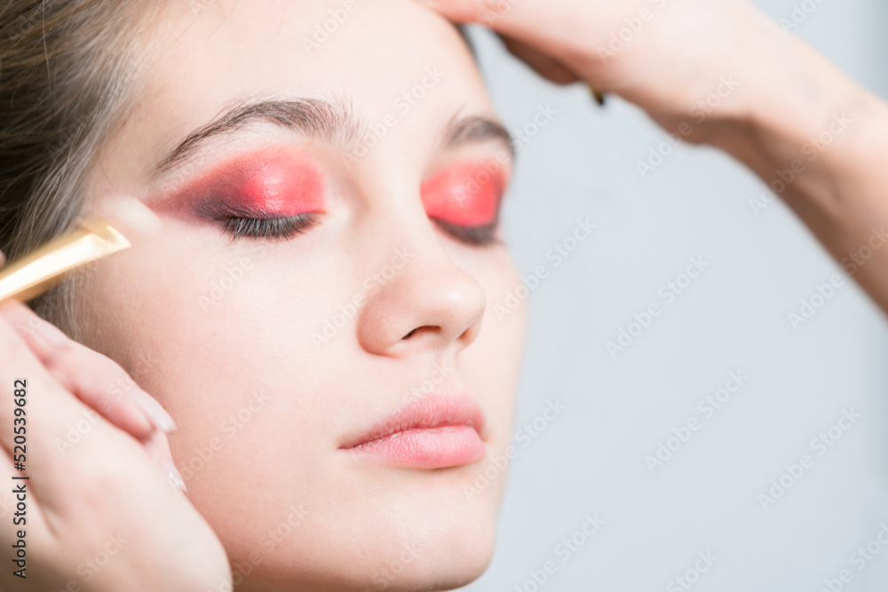 Applying bright makeup close-up. Red eyeshadow. Applying bright makeup close-up. Red eyeshadow.
