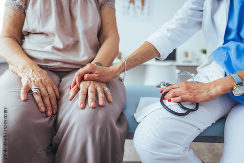 Health worker holding patient's hand. Cropped shot of a senior woman holding hands with a nurse. Doctor holding touching hands senior or elderly old lady woman patient with love, care, helping.
