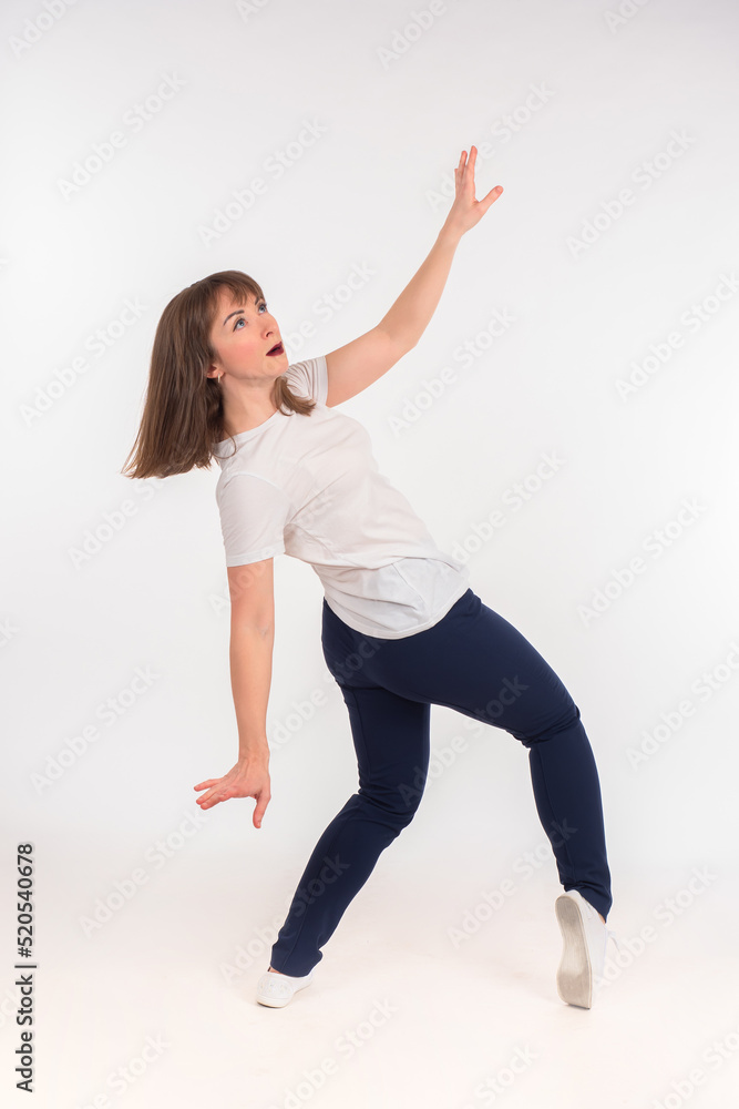 Obraz premium Stunned woman looks up. Something falls on girl concept. Woman leans down and waves her arms. Lady restrains fall of invisible object. Girl in full growth. Casual woman isolated on white