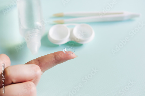 Women's hands with contact lenses and a container for contact lenses. Medicine and vision concept