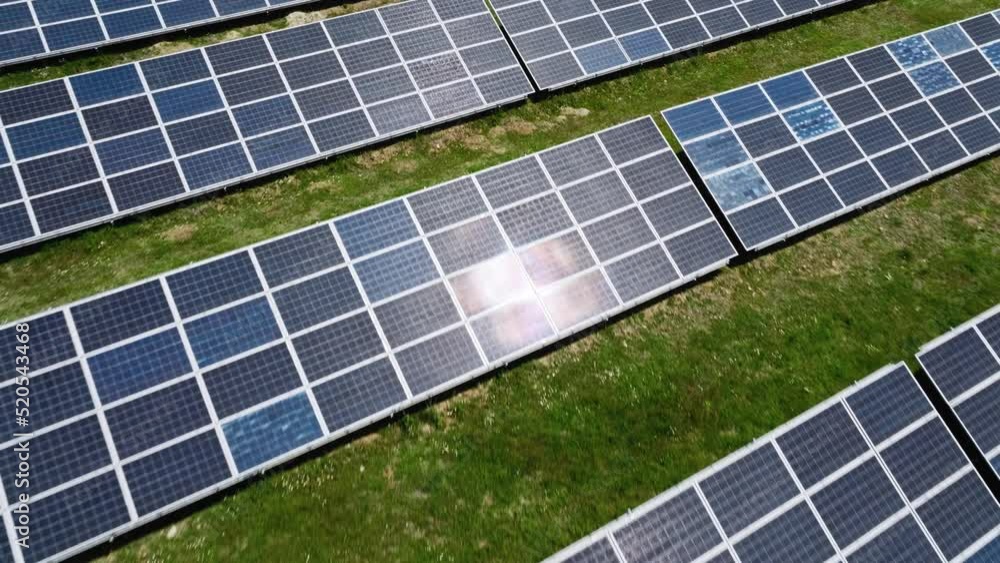 Blue solar panels reflecting light in a field Blue solar panels reflecting light in a field