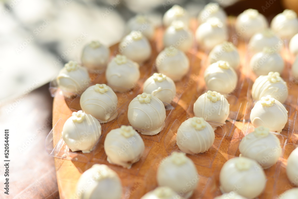 white chocolate pralines on the party table, condensed milk candy balls, candy balls