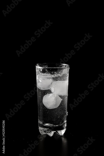 Glass of water filled with ice cubes