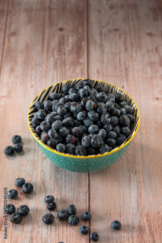 Blueberries in a bowl on wooden table