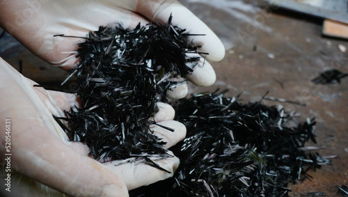 Hand holding carbon fiber material of composite