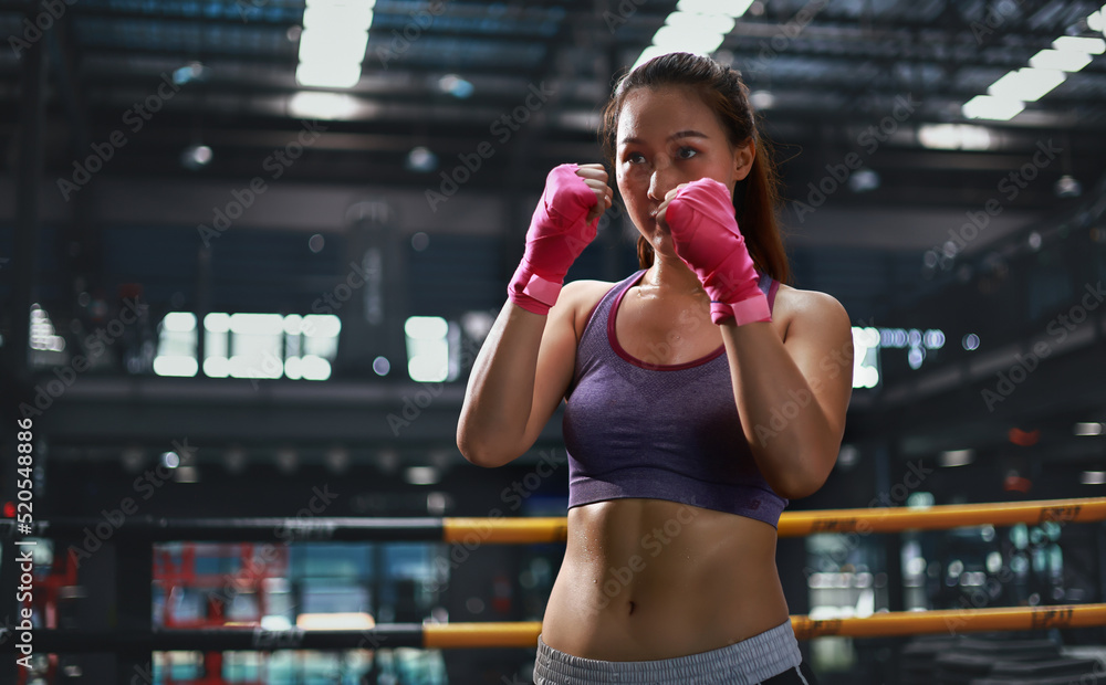 Young beautiful asia woman exericse shadow boxing in gym, Boxer practicing in fitness gym Young beautiful asia woman exericse shadow boxing in gym, Boxer practicing in fitness gym