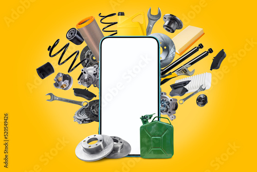 фотографія A various of new car spare parts and blank smartphone with white screen for your text or design on yellow background